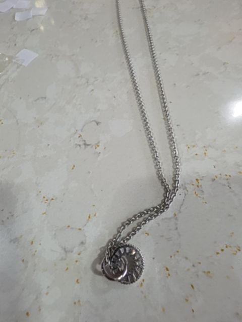 silver toned necklace wheel pendant